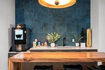 Resident co-working lounge with coffee bar and business center with pcs and wireless printing